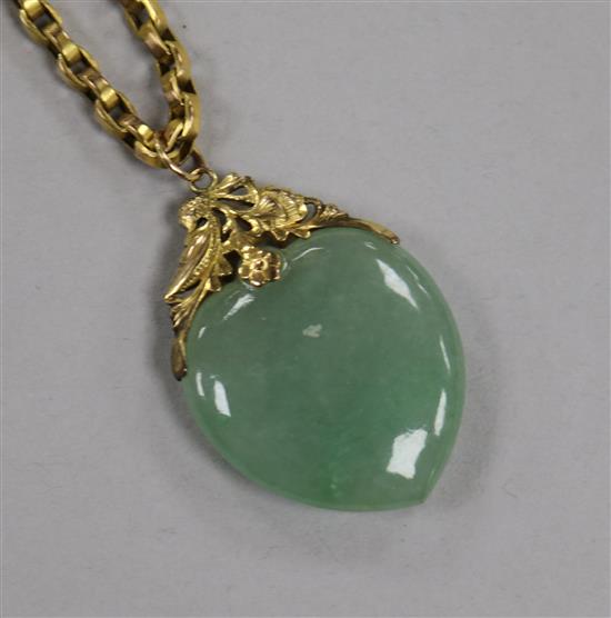 A yellow metal mounted heart shaped jade pendant, on a 9ct gold chain, pendant 39mm.